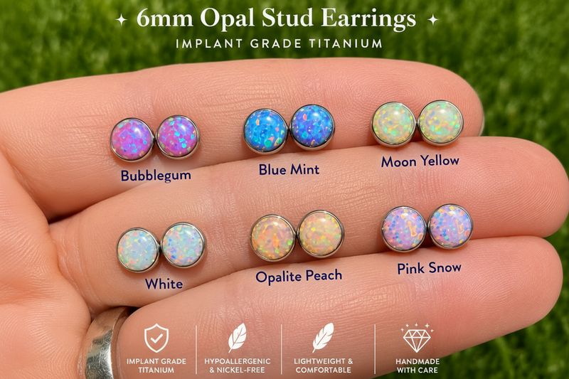 6mm Opal Stud Earrings on a hand with color options labeled against a grass background