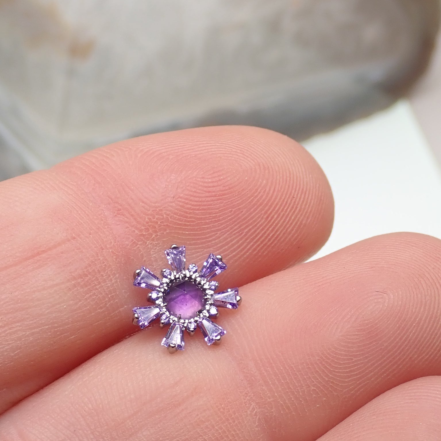 Amethyst and cubic zirconia cluster titanium flatback piercing in silver with purple gemstone accents.