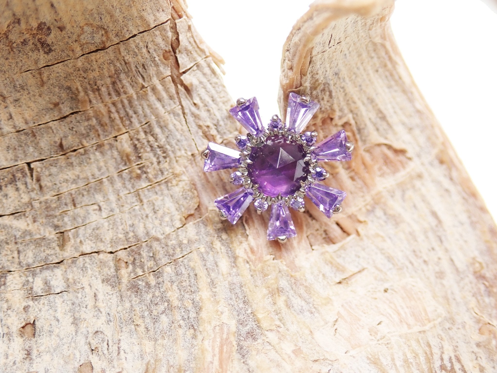 Amethyst and cubic zirconia cluster titanium flatback piercing with Medusa design by Body Clickers.