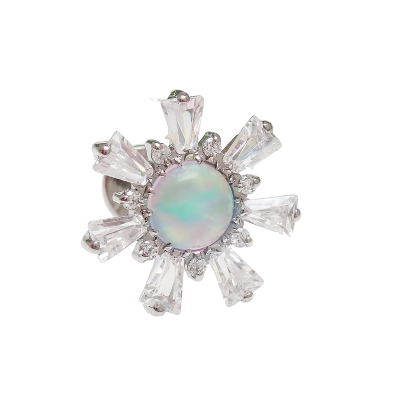 Jewelry with a central opal stone surrounded by clear gemstones on a white background.