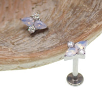 Rose quartz cluster titanium flatback piercing in 18g size, featuring a natural pink gemstone and sleek metal setting.
