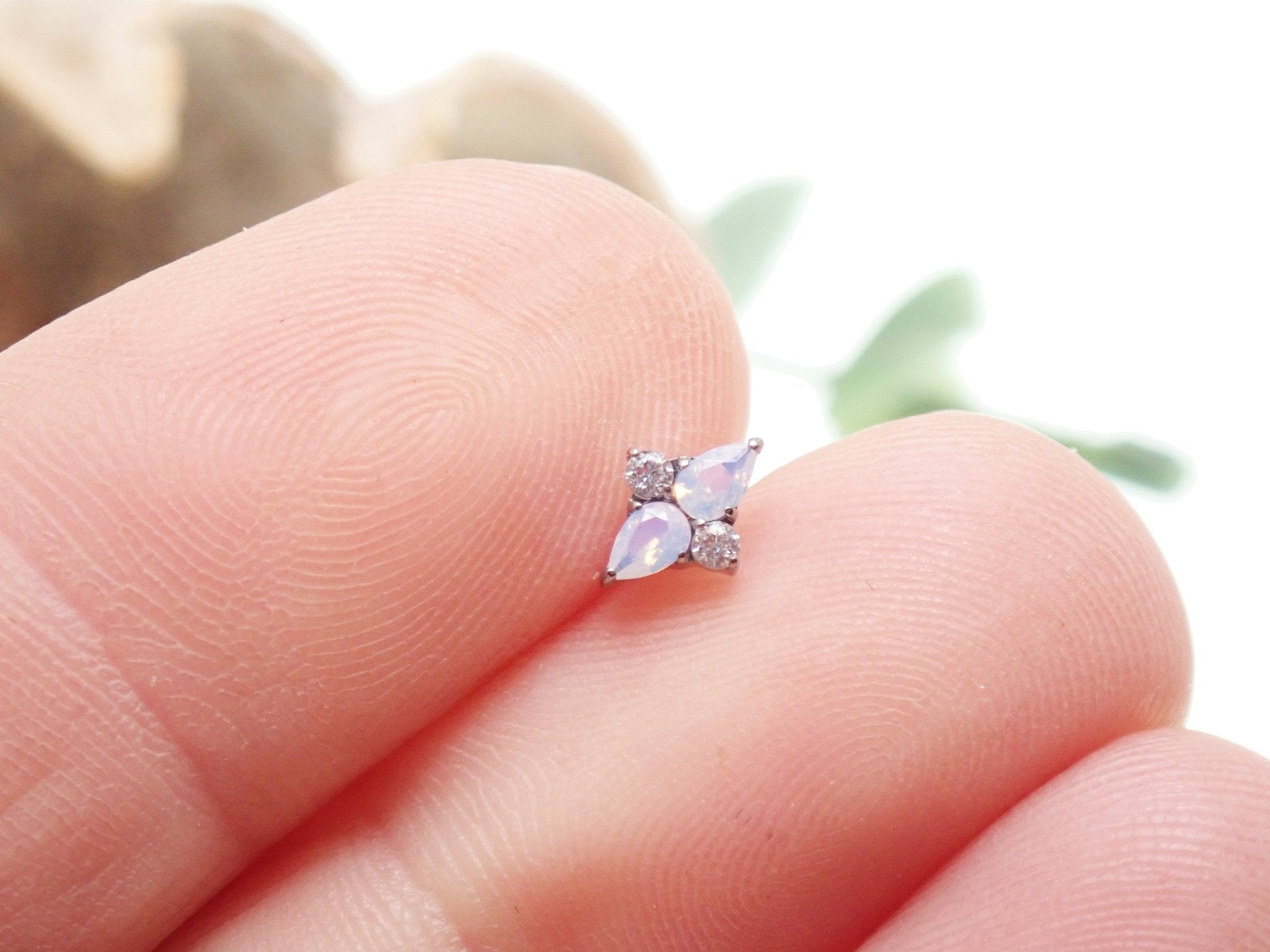 18G rose quartz cluster titanium flatback piercing by Body Clickers, featuring a sparkling pink gemstone and sleek metal design.