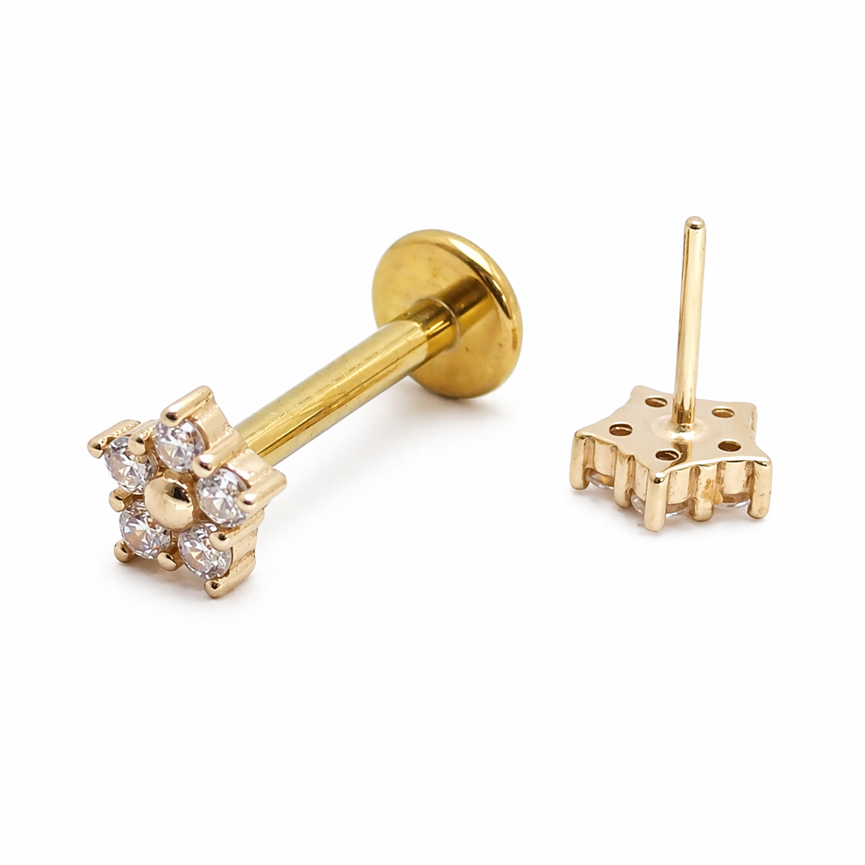 14k gold flower design titanium flatback push-fit labret piercing by Body Clickers displayed on skin.