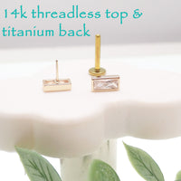 14k gold rectangle titanium flatback push-fit piercing by Body Clickers, showing the sleek, rectangular design on a skin model.