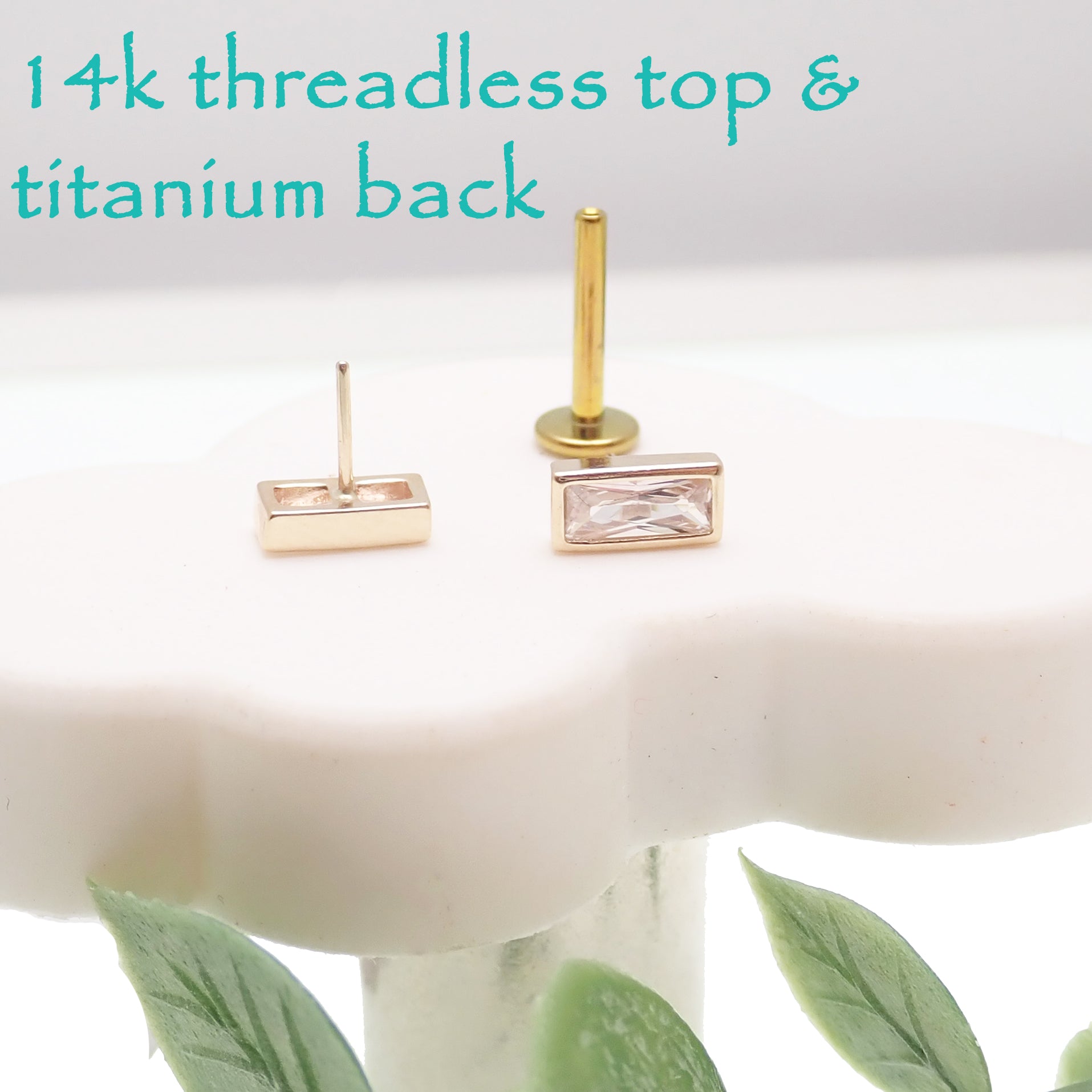 14k gold rectangle titanium flatback push-fit piercing by Body Clickers, showing the sleek, rectangular design on a skin model.