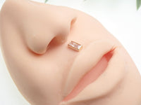 14k gold rectangle flatback push-fit piercing by Body Clickers, showcasing a sleek titanium design for comfortable wear.