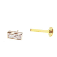 14k gold rectangle titanium flatback push-fit piercing by Body Clickers, shown in a close-up image of the jewelry.