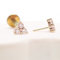 14k gold Trinity and titanium flatback push-fit piercing by Body Clickers, featuring sleek, modern design for comfortable wear.