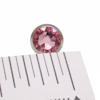 Green or pink CZ tongue barbell piercing in titanium, 14g, by Body Clickers with colorful cubic zirconia accents.