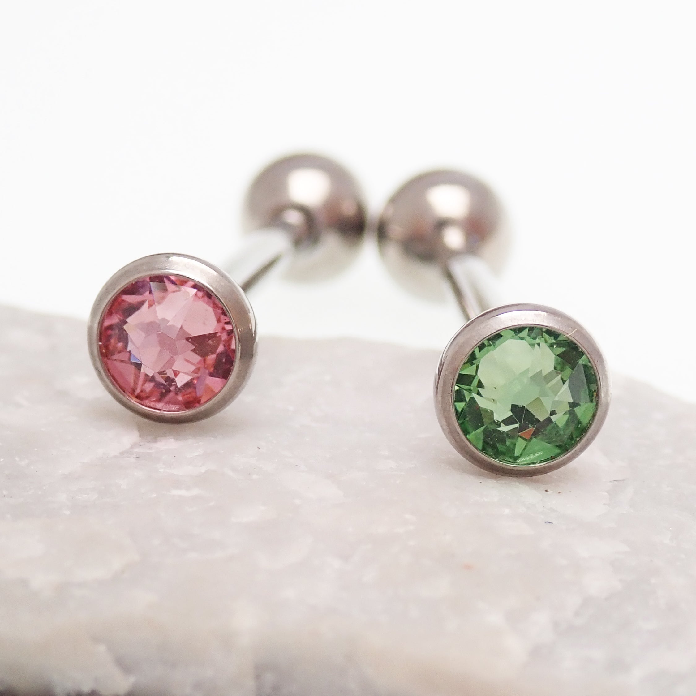 Green or pink CZ tongue barbell piercing by Body Clickers, 14g titanium jewelry with colorful cubic zirconia accents.