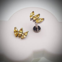 Citrine yellow CZ flatback body jewelry by Body Clickers in 14g, 16g, or 18g for piercings, shown in a close-up image.