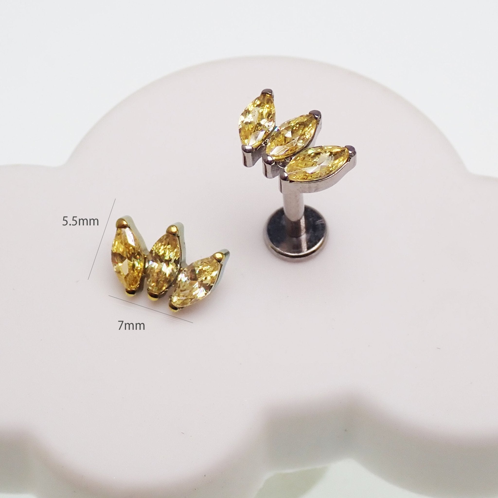 Citrine yellow CZ flatback body jewelry in 14g, 16g, and 18g sizes from Body Clickers, with shiny, faceted stones.