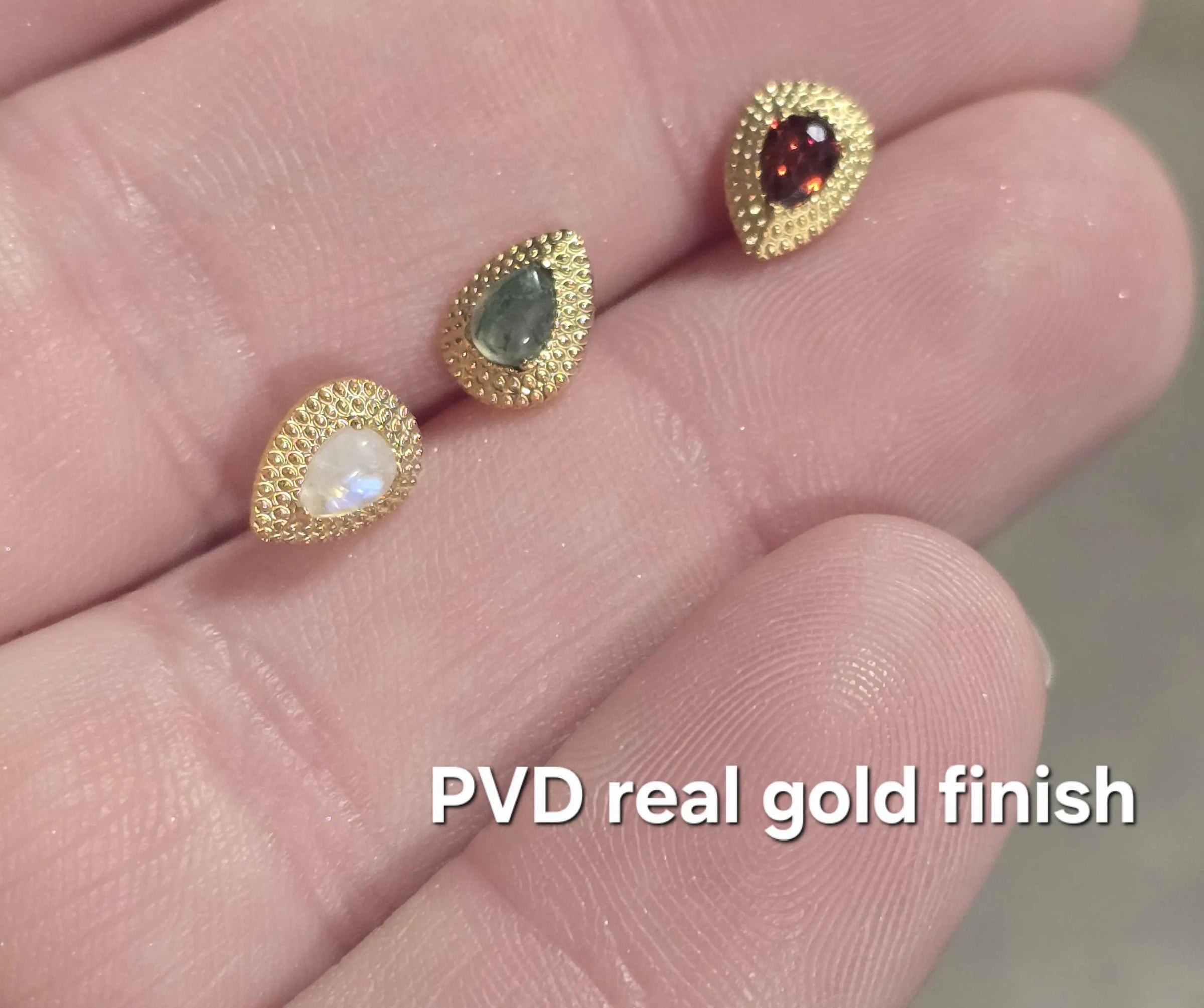 Titanium push-fit teardrop piercing with Moss Agate, garnet, and moonstone in a single stud, designed for body jewelry piercing.