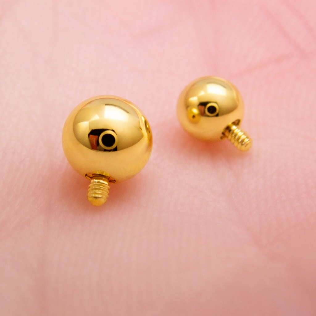 Internally threaded titanium PVD gold ball attachments for body jewelry, available in 14g and 16g gauges.