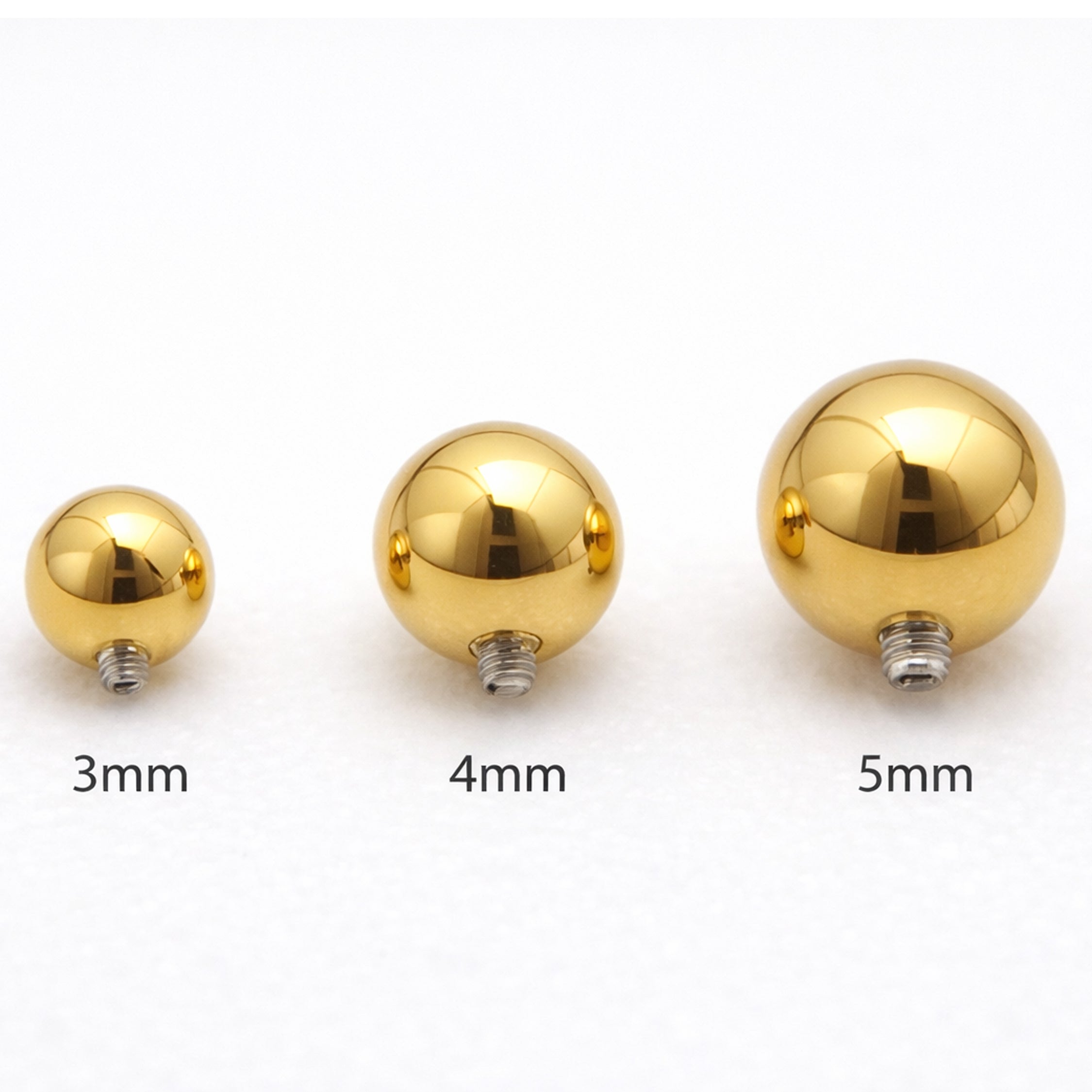 Internally threaded titanium PVD gold ball attachments for body jewelry in 14g and 16g sizes, by Body Clickers.