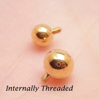 Internally threaded titanium PVD gold ball attachments for body jewelry in 14g and 16g gauges, by Body Clickers.
