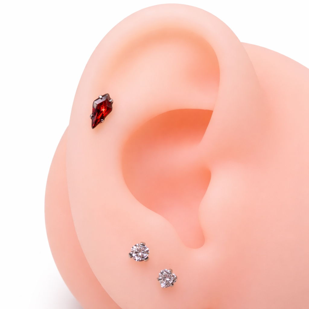 Implant grade titanium push-fit threadless piercing with a single garnet stone flatback, suitable for body jewelry.