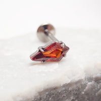 Implant grade titanium push-fit threadless piercing with a single garnet stone flatback, designed for body jewelry.