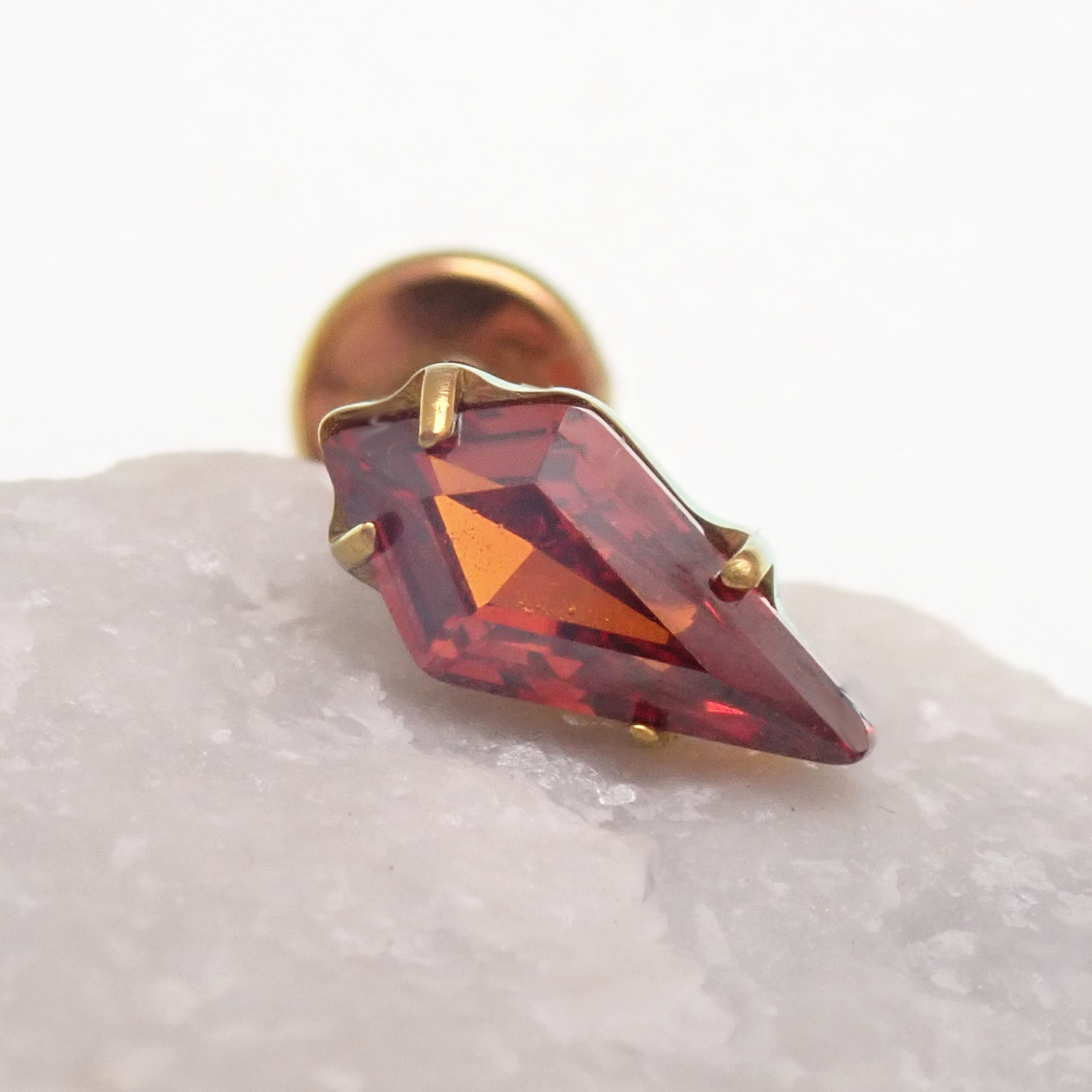 Titanium push-fit threadless piercing with a single garnet stone, flatback design, by Body Clickers Body Jewelry.