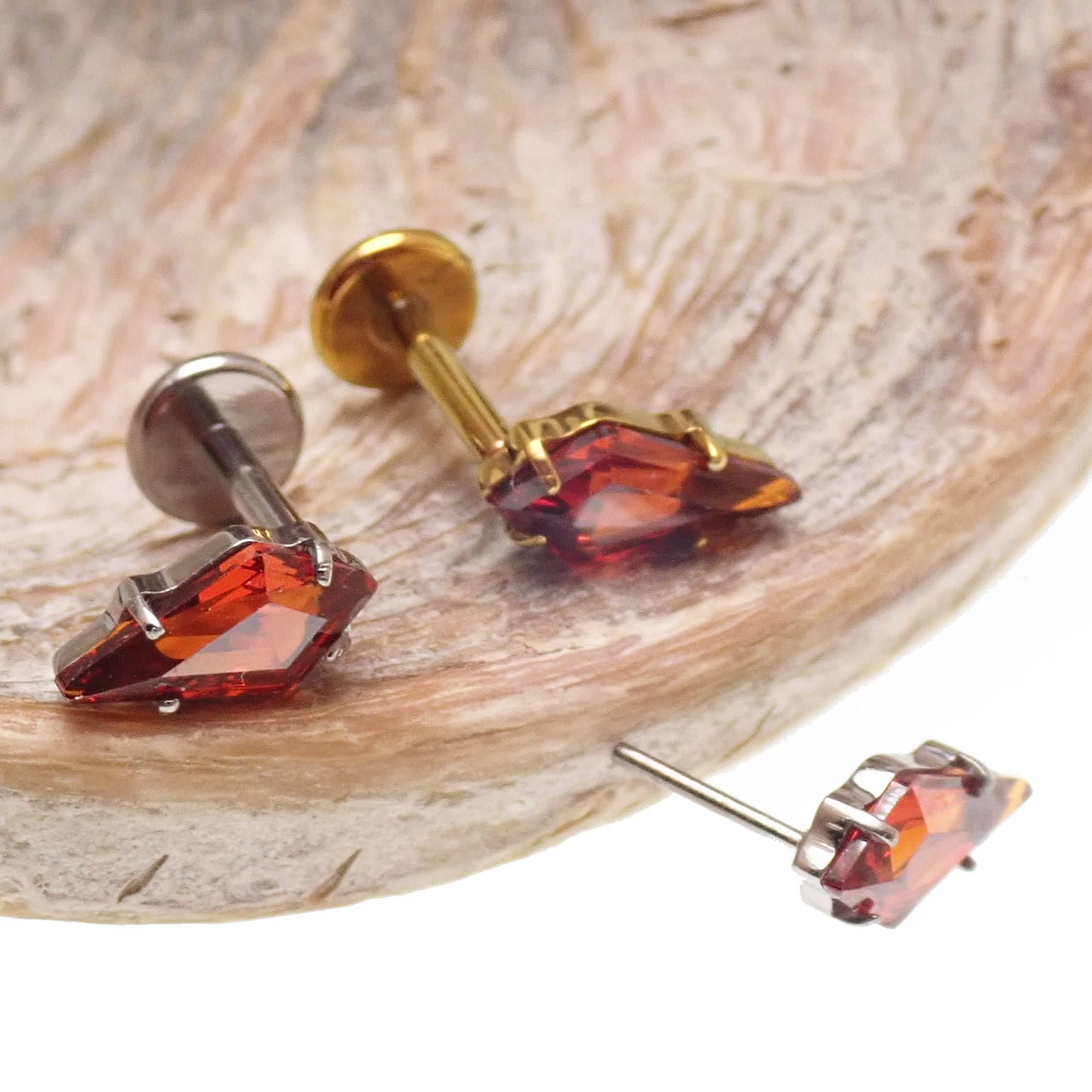 Titanium push-fit threadless piercing with a 5mm garnet stone, flatback design, from Body Clickers Body Jewelry.
