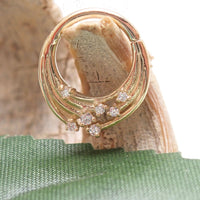 14k gold cosmic septum and daith clicker in 16g, featuring celestial designs and secure clasp for body jewelry piercing.