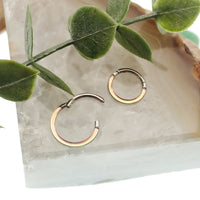 Photochromic epoxy clicker ring from Body Clickers Body Jewelry, 16g, 8mm, featuring color-changing effects.