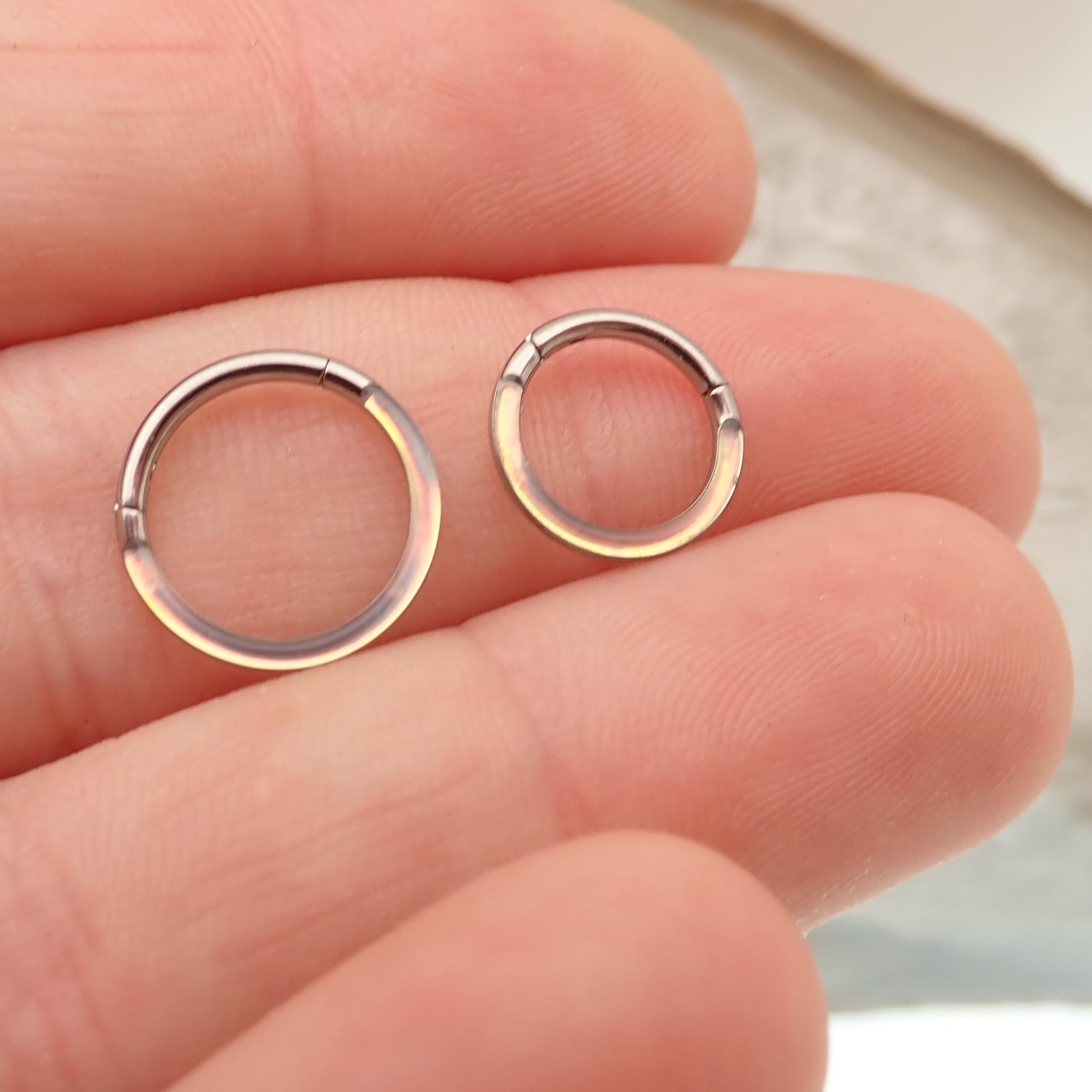 Photochromic epoxy clicker ring in 16g from Body Clickers Body Jewelry, featuring an 8mm design and adjustable clicker closure.