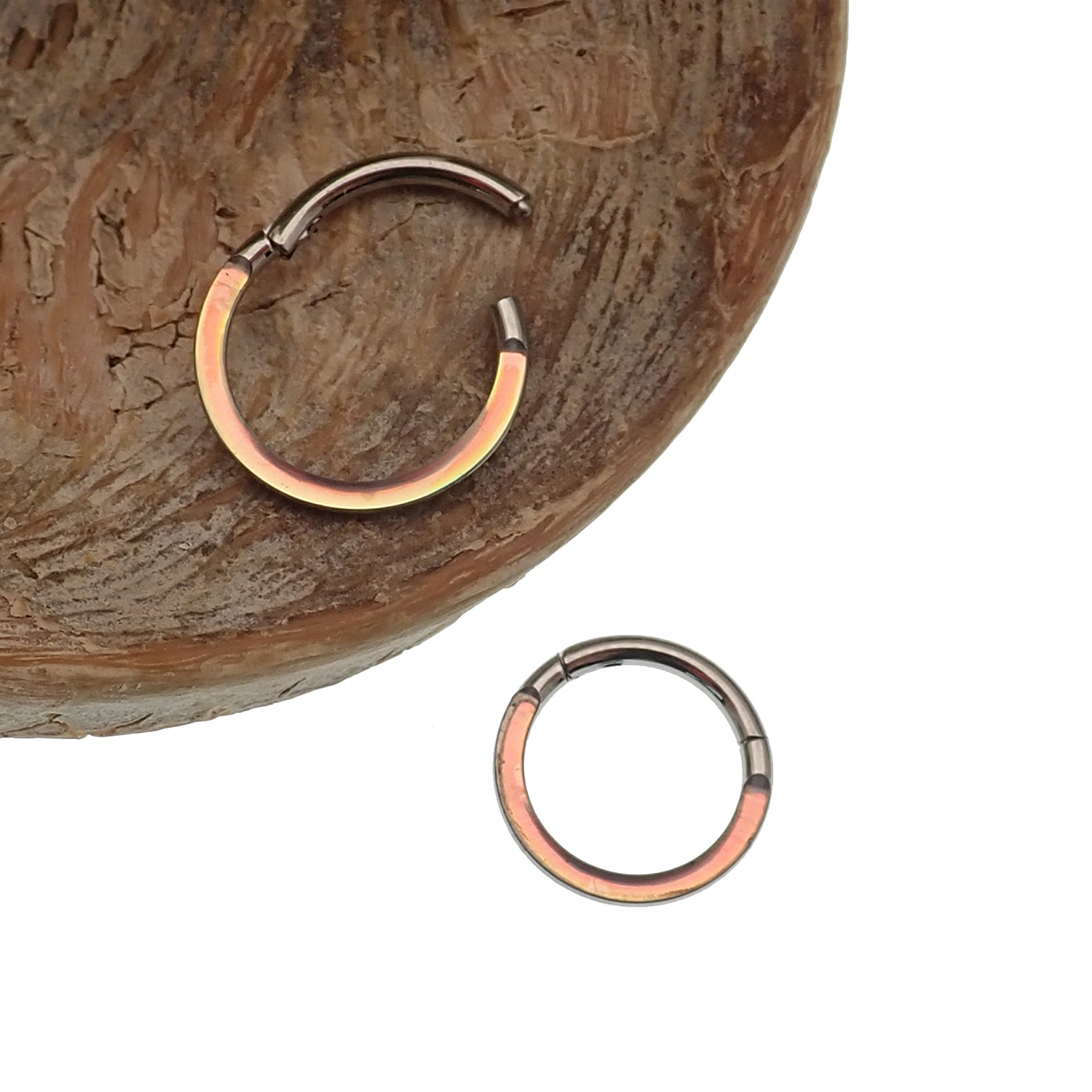 Photochromic epoxy clicker ring by Body Clickers Body Jewelry, 8mm, 16g, featuring color-changing design and smooth metal finish.