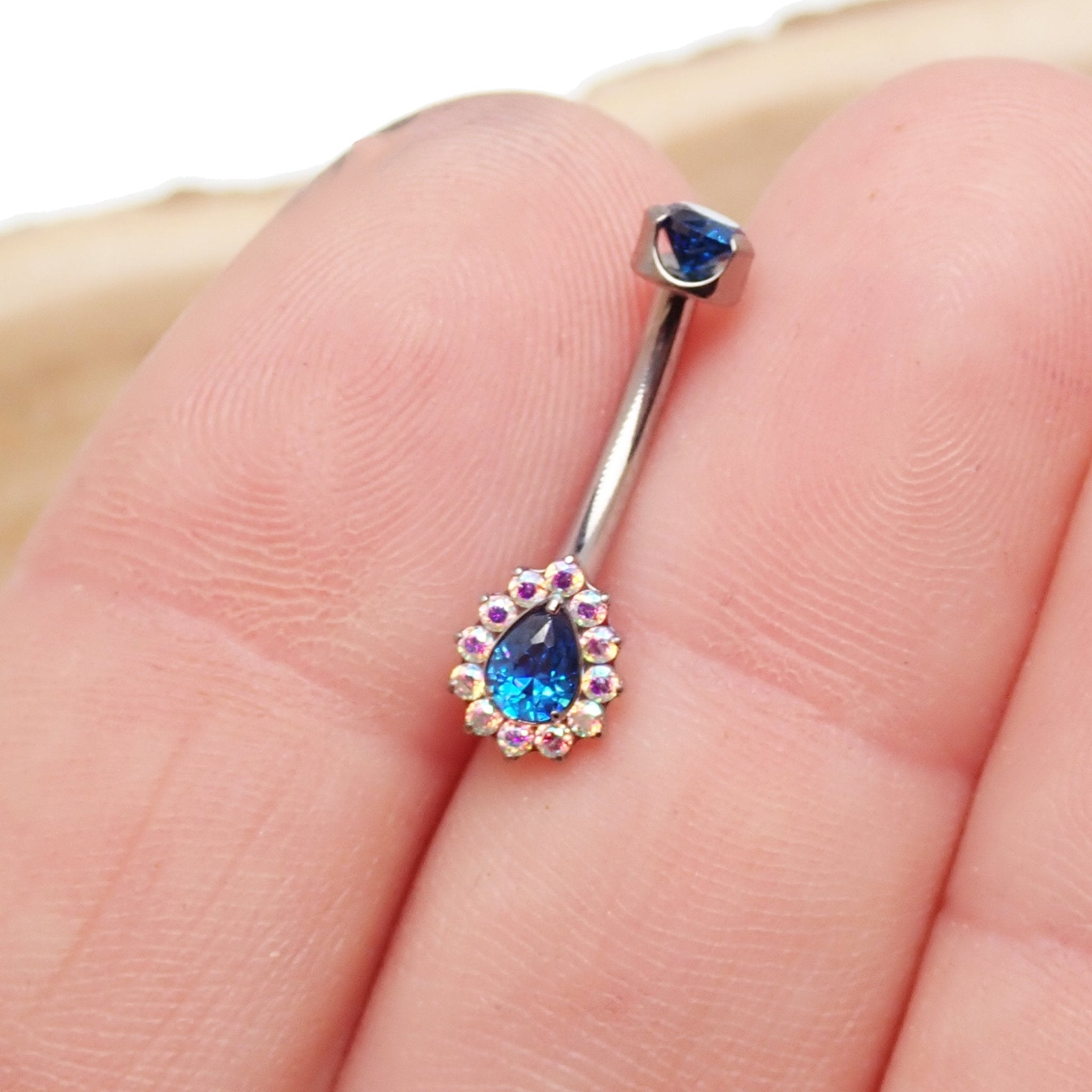 Cerise pink titanium internally threaded 14g belly ring by Body Clickers Body Jewelry showing the curved design and smooth finish.