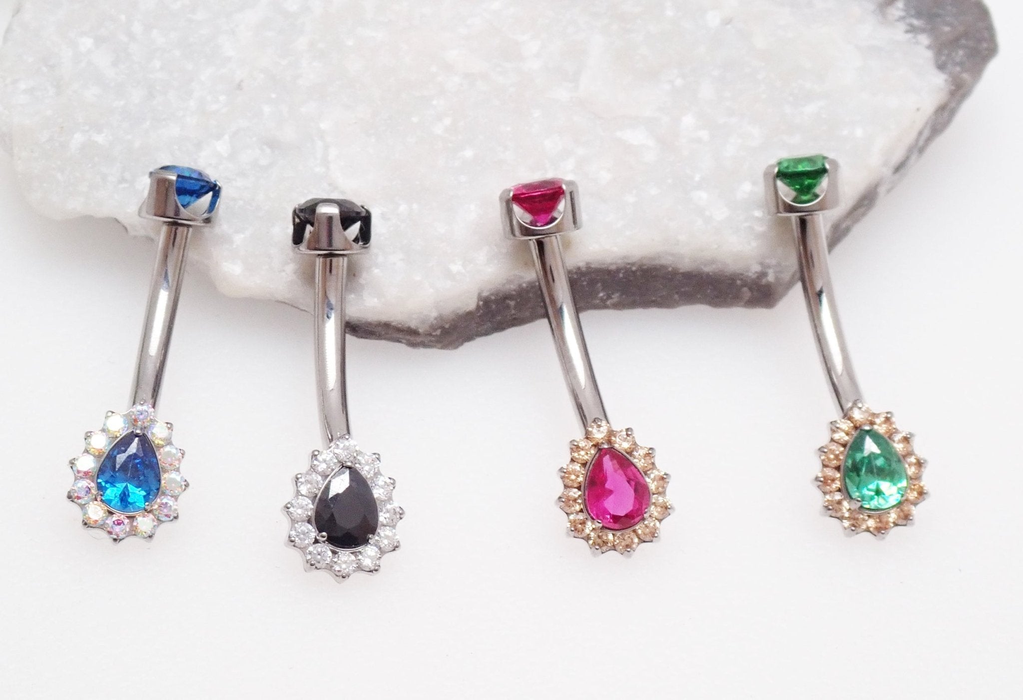 Cerise pink titanium internally threaded belly ring in 14g with curved bar and decorative ball from Body Clickers Body Jewelry.