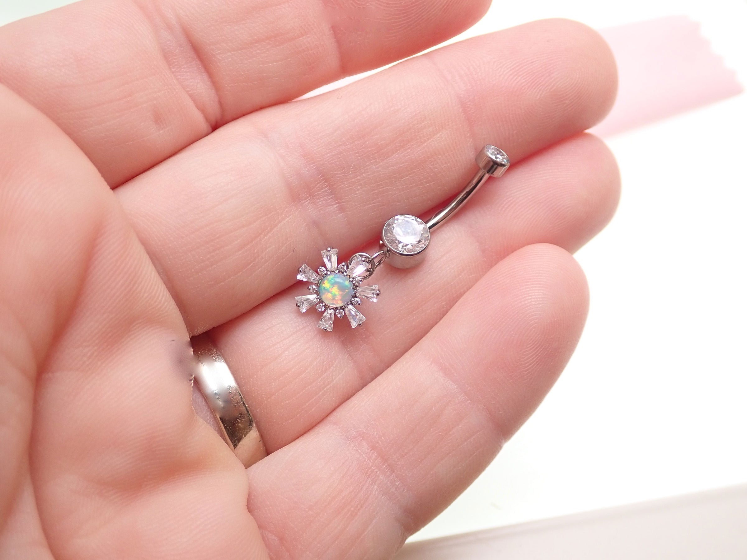 Titanium 14g dangly drop belly ring by Body Clickers with a sleek implant design and decorative hanging element.