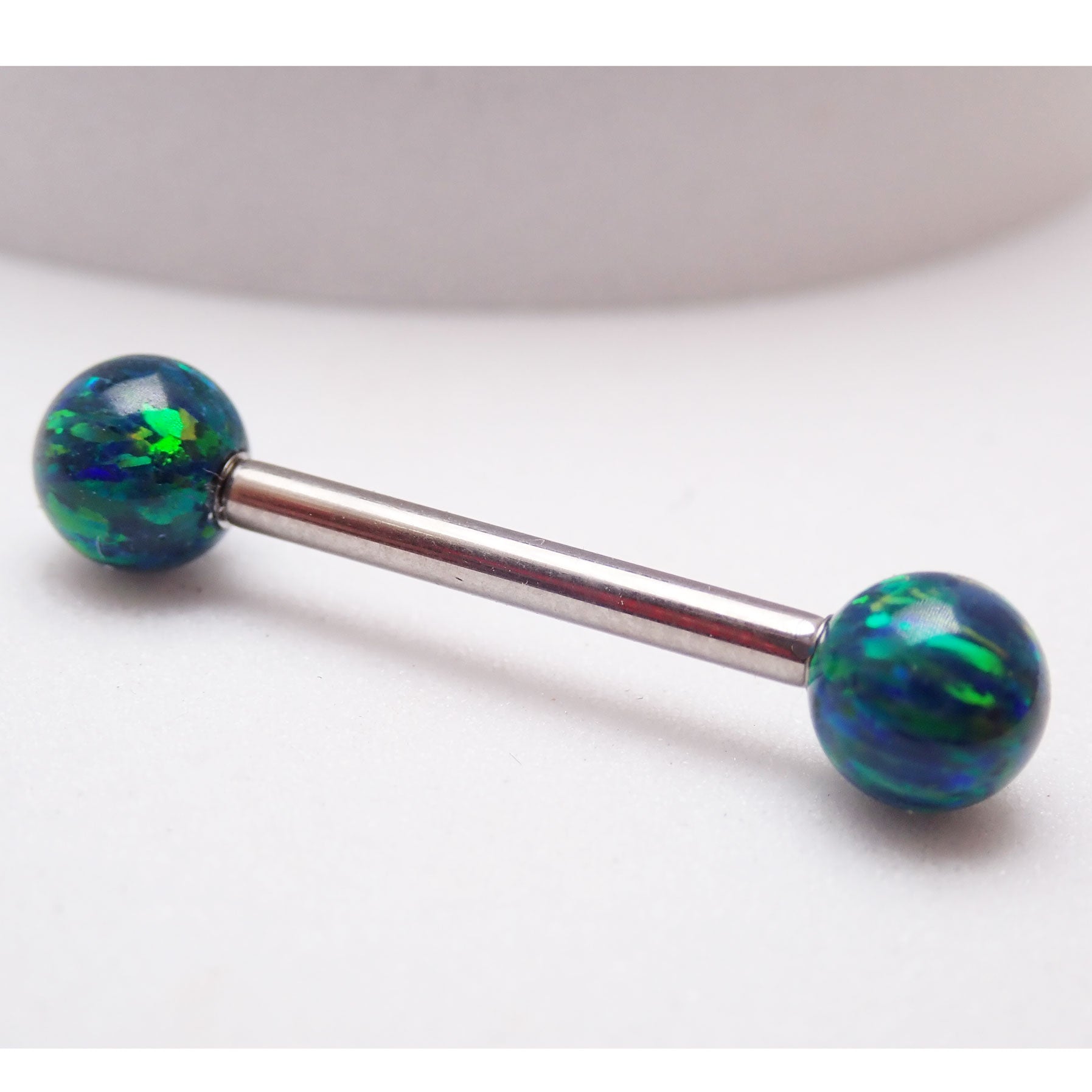 Galaxy green fire opal titanium nipple ring with 5mm balls, 14g and 12g body jewelry from Body Clickers Body Jewelry.