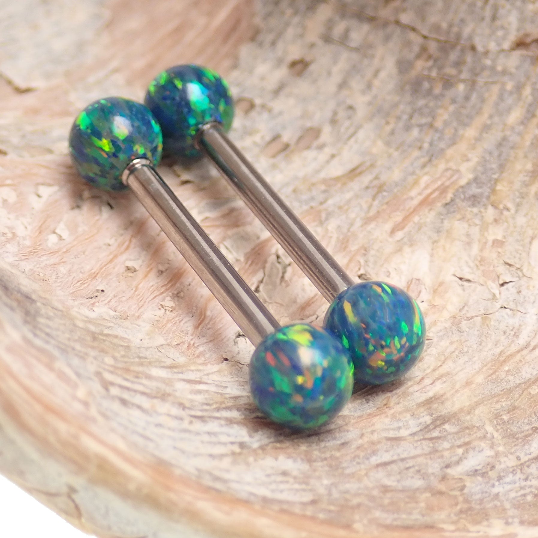 Galaxy green fire opal titanium nipple ring with 5mm opal balls, 14g and 12g body jewelry by Body Clickers.