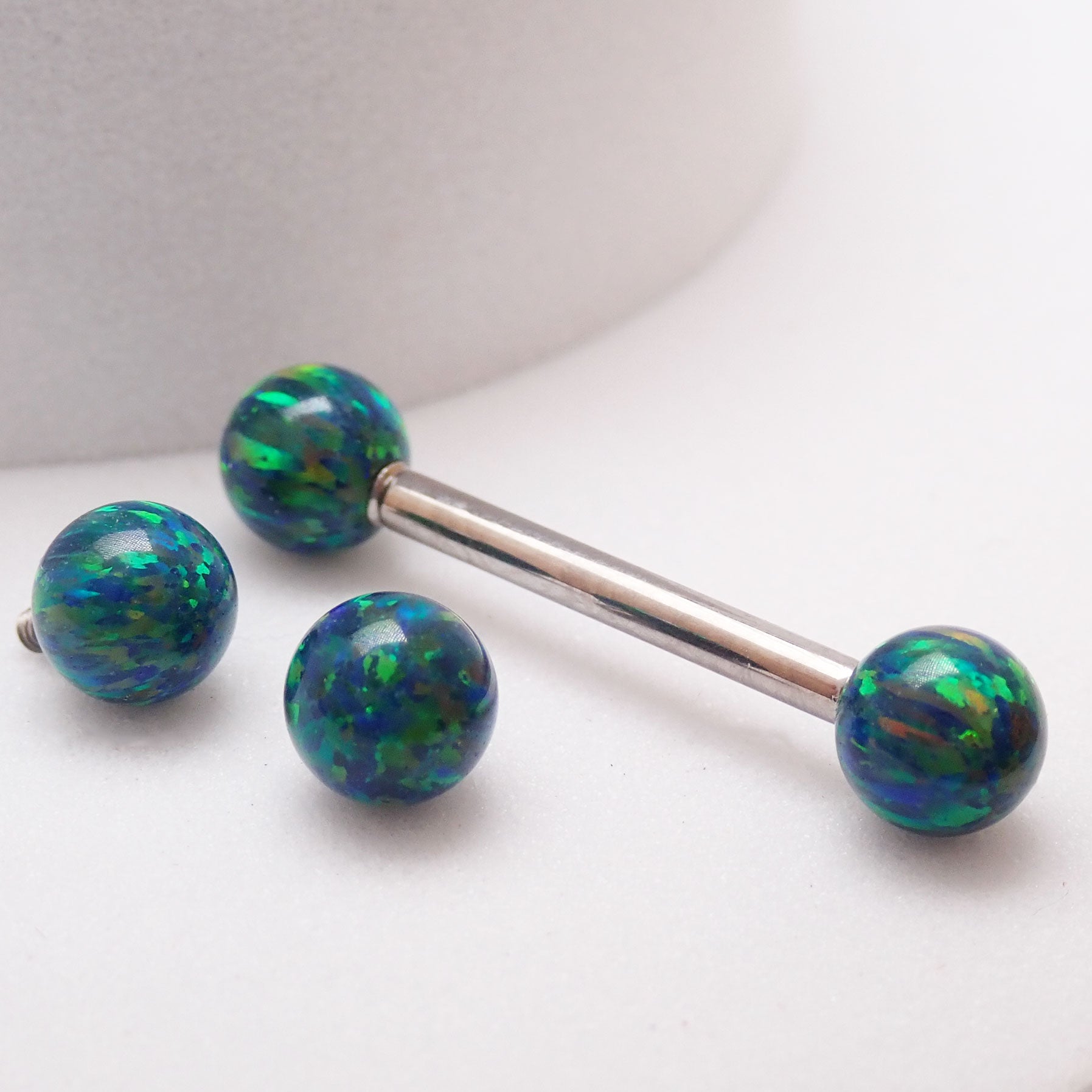 Galaxy green fire opal titanium nipple ring with 5mm opals, 14g and 12g body jewelry by Body Clickers Body Jewelry.
