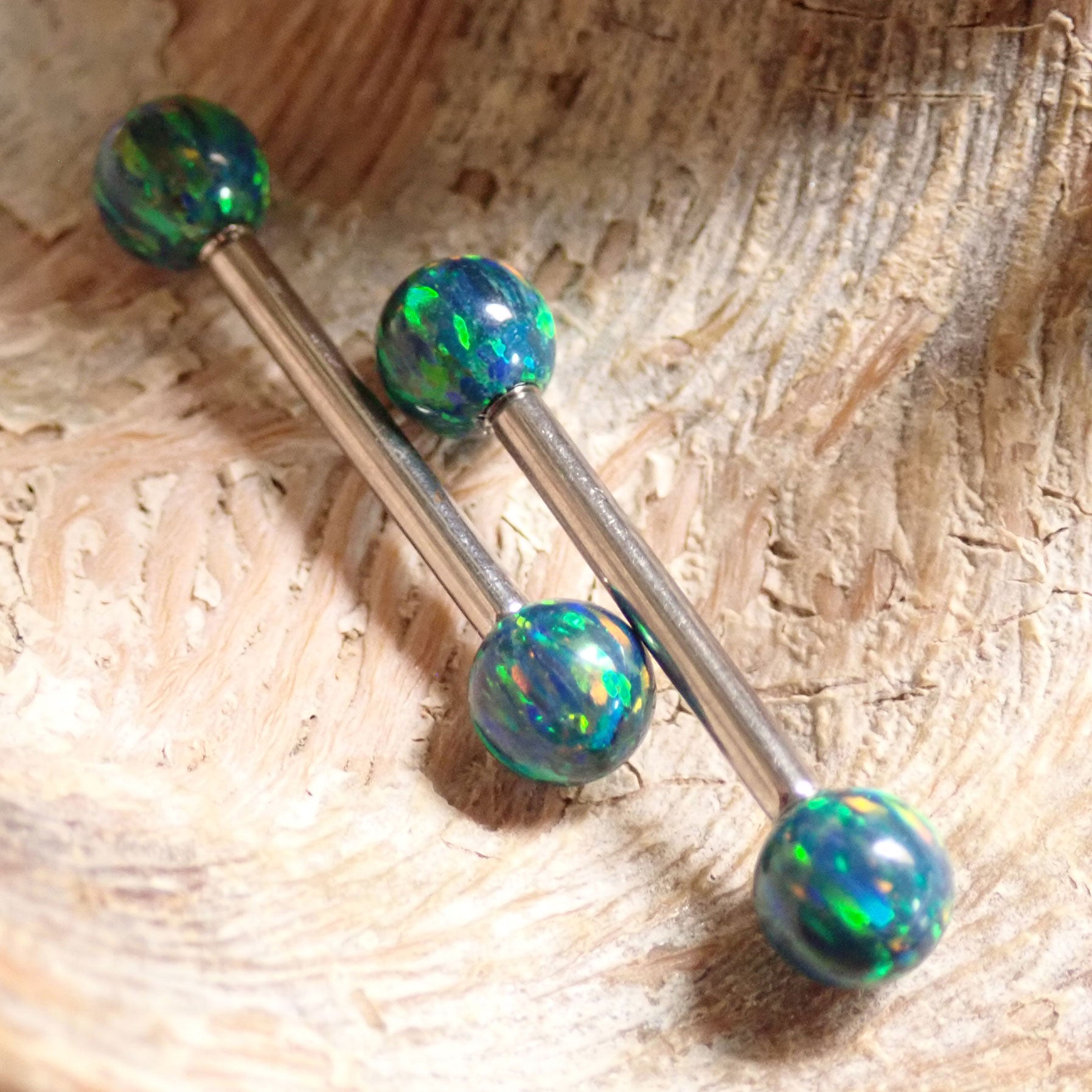 Galaxy green fire opal titanium nipple ring with 5mm balls, body jewelry in 14g and 12g gauges, by Body Clickers Body Jewelry.