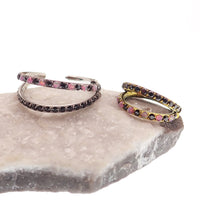 Pink and black conch-shaped body jewelry with double layer 16g split opal and cubic zirconia in a titanium clicker design.