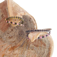 Pink and black conch-shaped titanium clicker body jewelry featuring split opal and cubic zirconia accents.