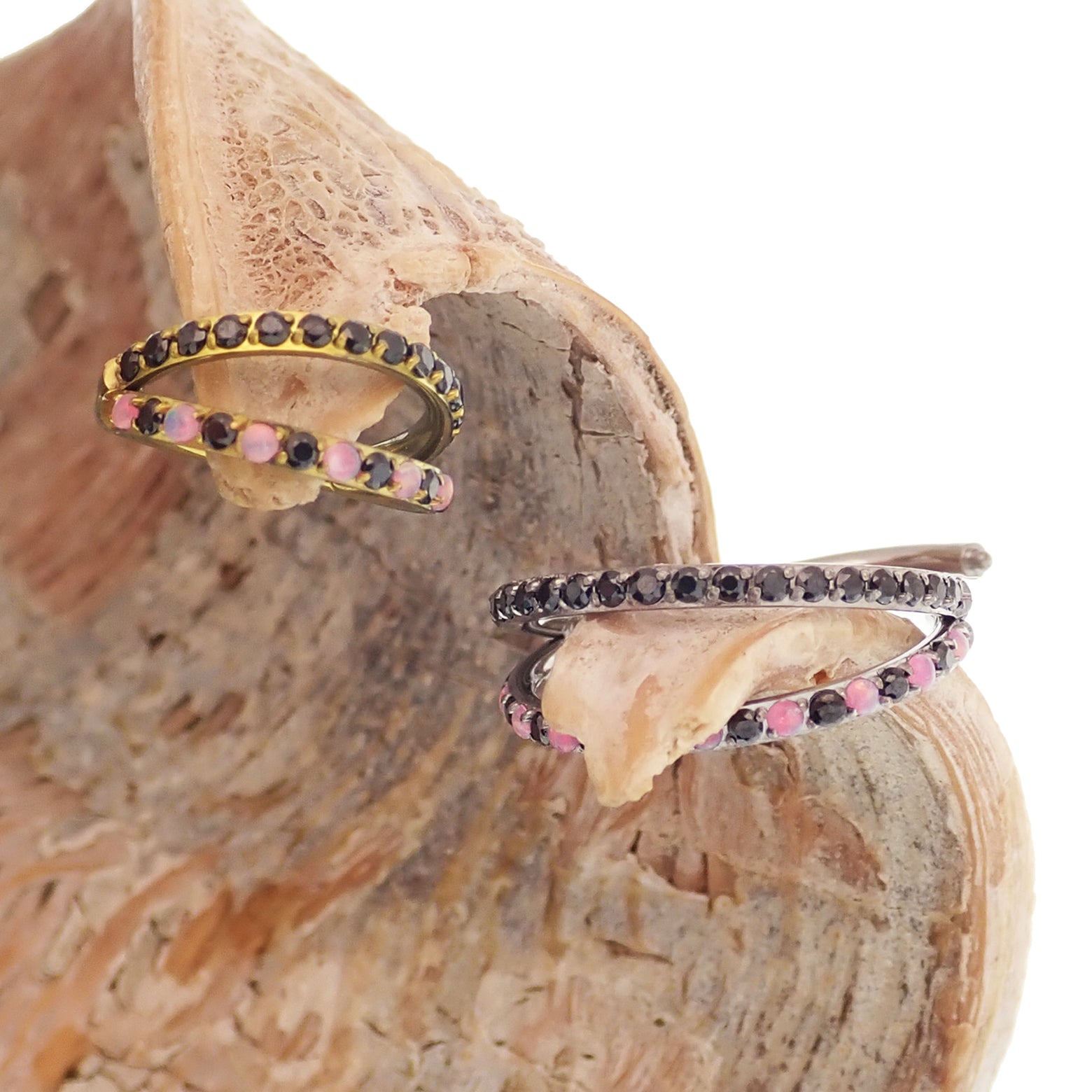 Pink and black conch-shaped titanium clicker body jewelry featuring split opal and cubic zirconia accents.
