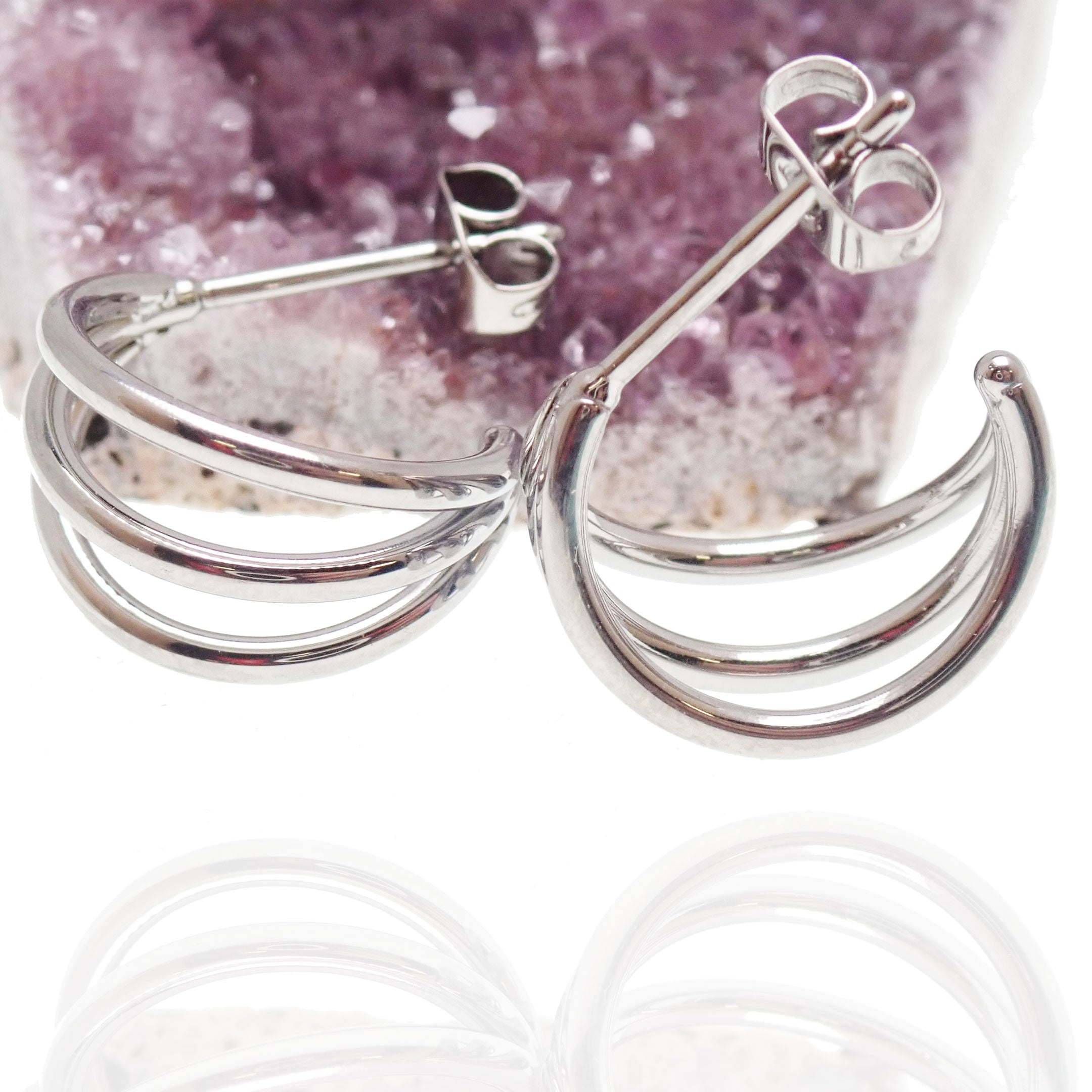 Triple hoop stud earrings made of implant-grade titanium, hypoallergenic body jewelry with a sleek, minimalist design.