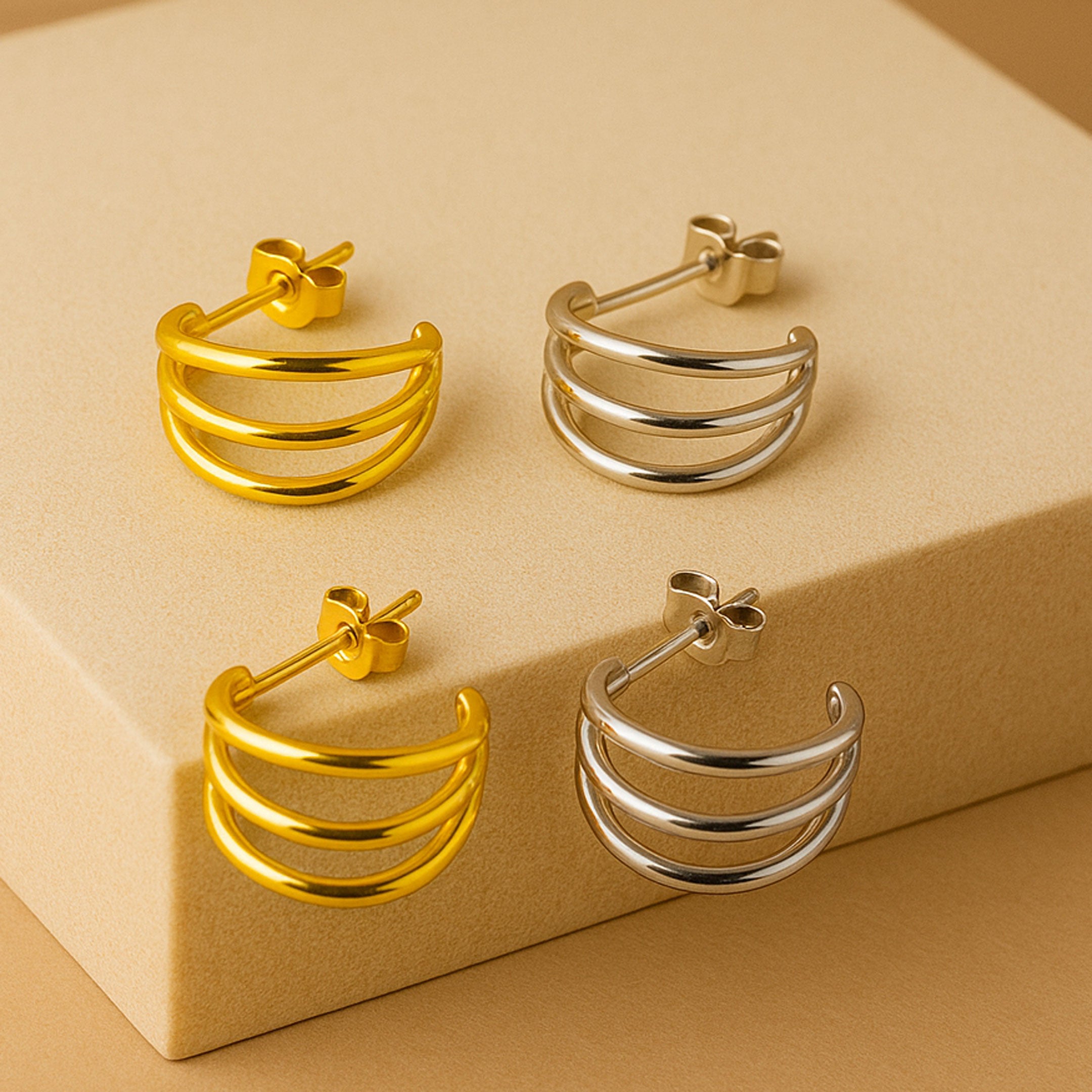 Triple hoop stud earrings made of hypoallergenic implant titanium, designed by Body Clickers Body Jewelry for sensitive ears.