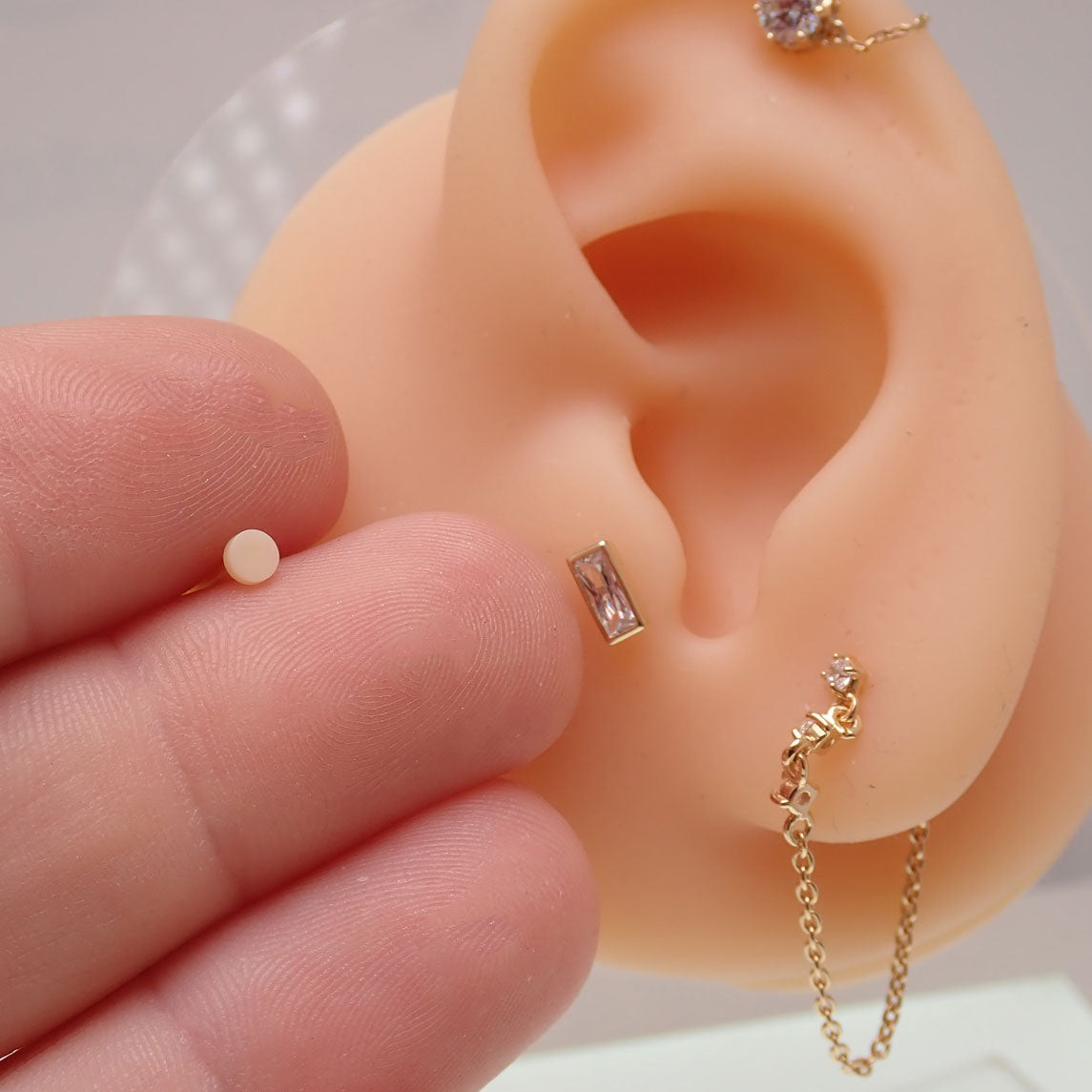 Pair of flat back Bio Flexible PTFE labret piercings from Body Clickers, hypoallergenic and 16g for discreet body jewelry.