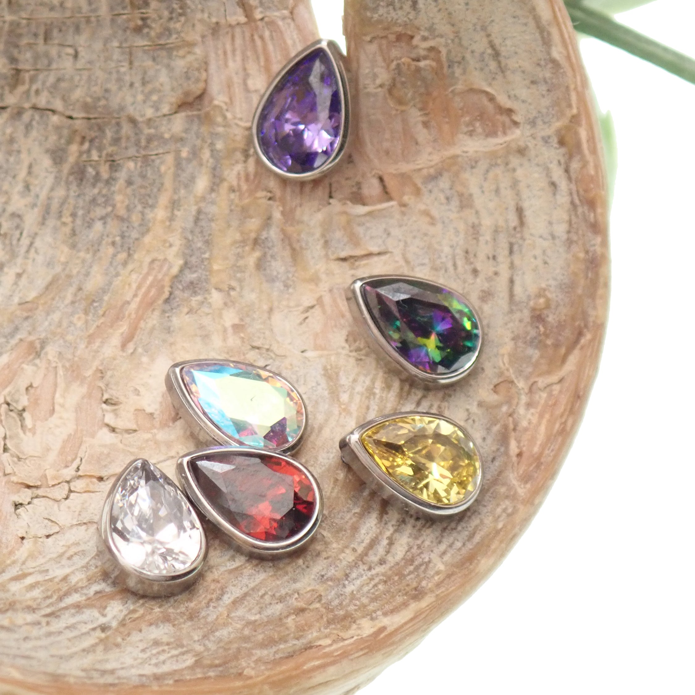 Large CZ teardrop flat back body jewelry by Body Clickers in 14g, 16g, 18g with garnet-colored stone and 6mm size.