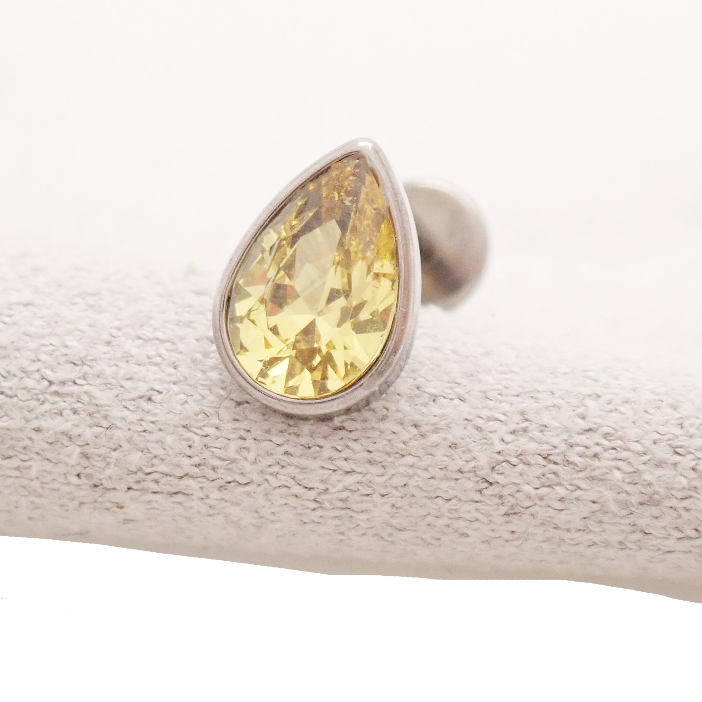 Large CZ teardrop flat back body jewelry by Body Clickers in 14g, 16g, 18g with a 6mm garnet-colored stone, designed for body piercings.
