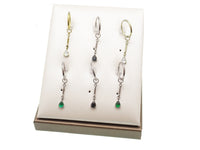 Green 8mm 20g titanium hoop earring with charm dangle from Body Clickers Body Jewelry, showcasing a sleek, lightweight design.