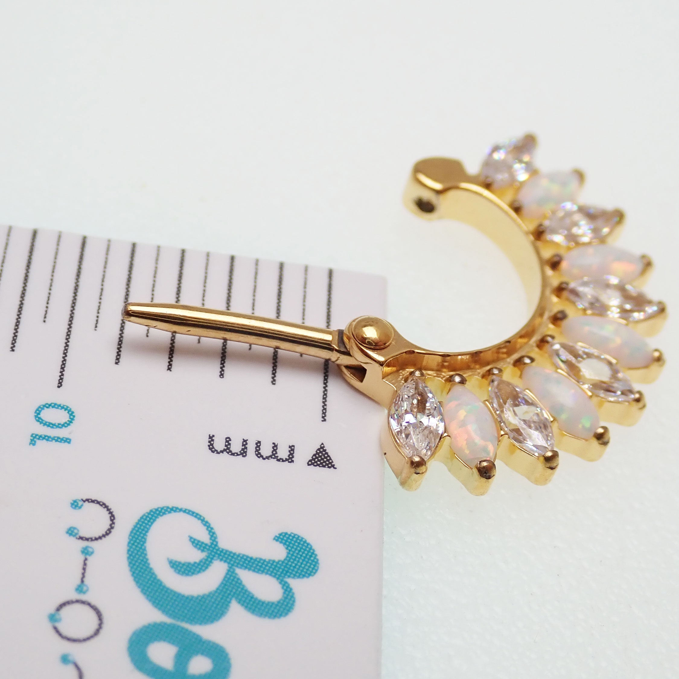 Implant grade titanium small gold 16g hinged clicker with 7mm diameter body jewelry for piercings.