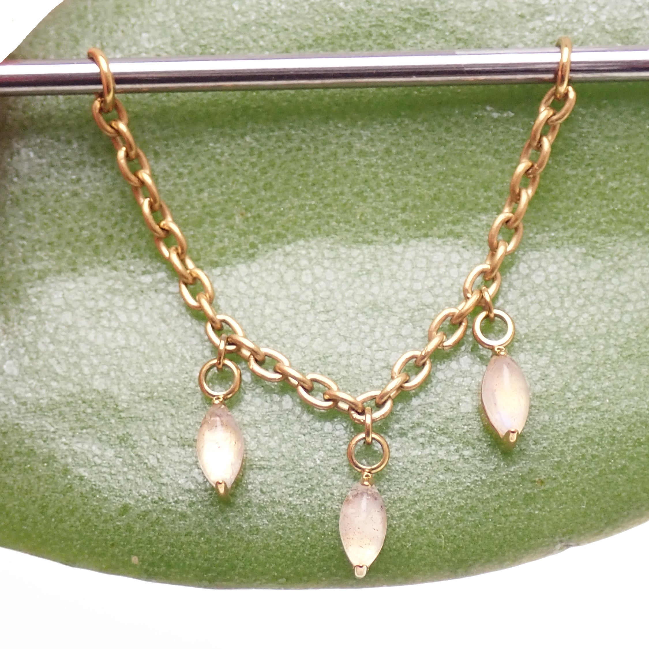 Titanium implant body jewelry with moss agate and moonstone charms, featuring a natural stone piercing chain.