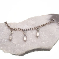 Titanium implant body jewelry with moss agate and moonstone charms, featuring a natural stone piercing chain.