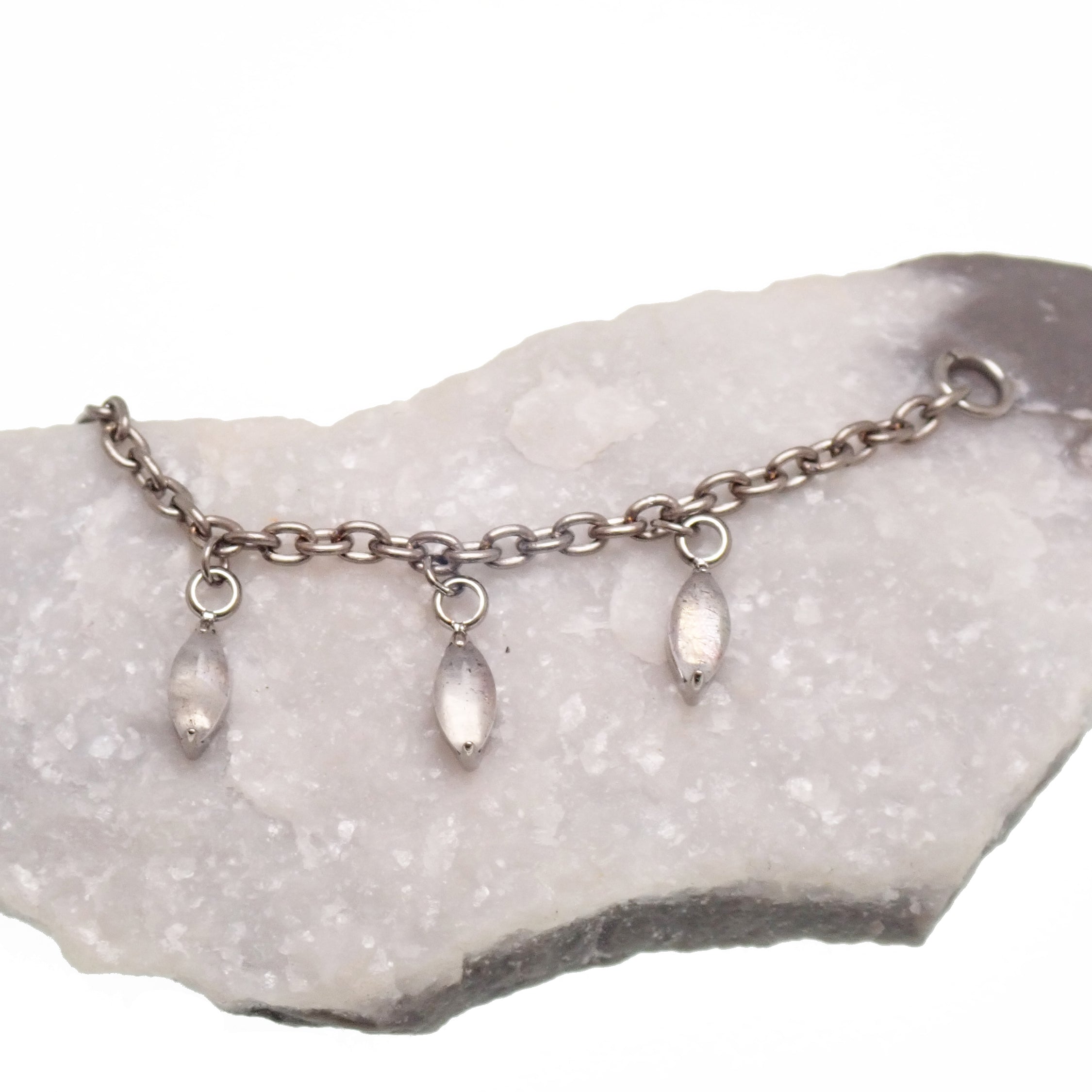 Titanium implant body jewelry with moss agate and moonstone charms, featuring a natural stone piercing chain.