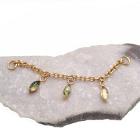 Implant titanium body jewelry chain with moss agate and moonstone charms, featuring natural stone accents and intricate design.
