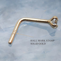 14K gold nose stud with 2mm cubic zirconia from Body Clickers Body Jewelry, featuring a simple, elegant design for nose piercing.